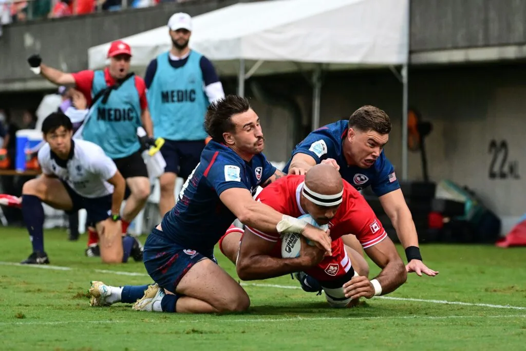 USA defenders tackle a Canadian ball carrier during the Canada vs USA Pacific Nations Cup third-place playoff in Tokyo
